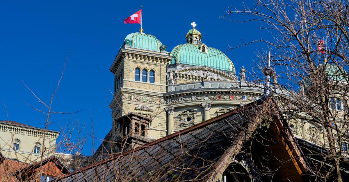Photo of the Swiss Federal Palace in Bern, featuring distinctive architecture under a clear blue sky.
